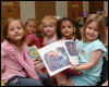 Group of children holding a book